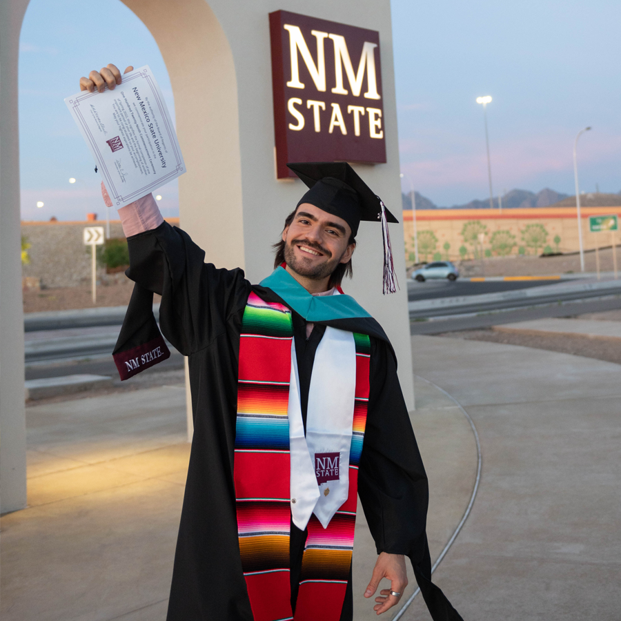 Student posting with diploma